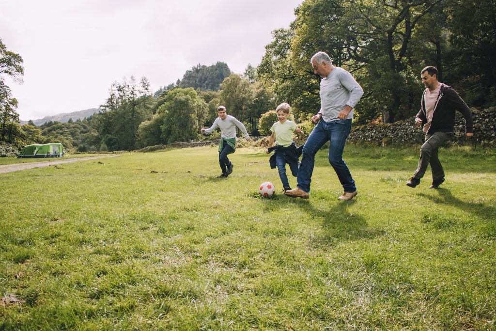 young family enjoying play in the park