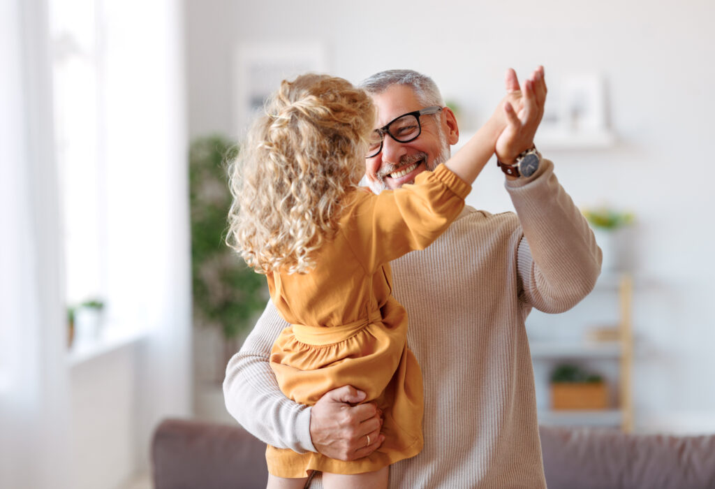 Father and daughter dancing in the kitchen