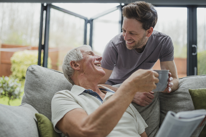 Grown son and father discussing life insurance